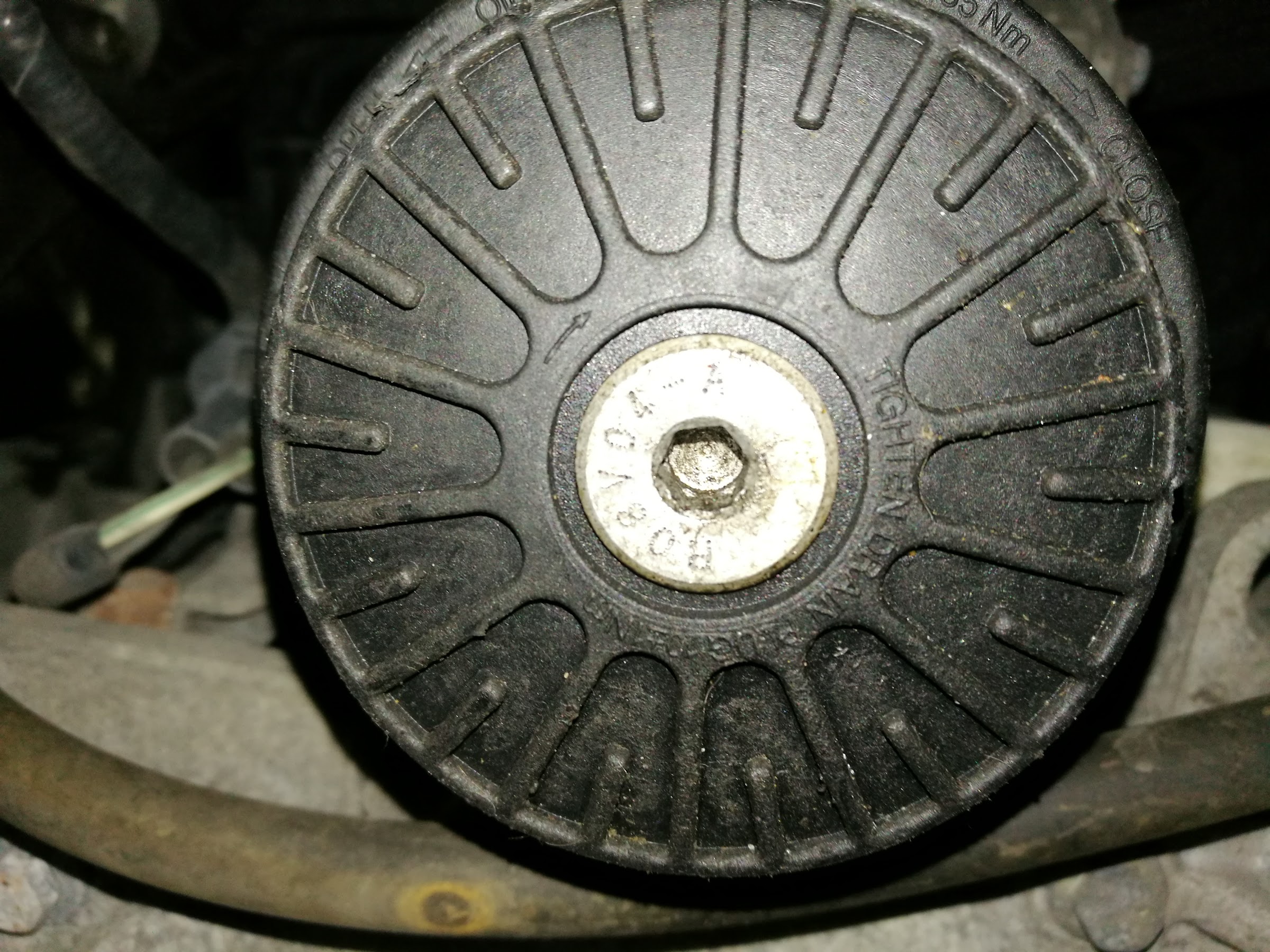 A worn drive pulley photographed underneath a vehicle during diagnosis at D and M Auto Repair